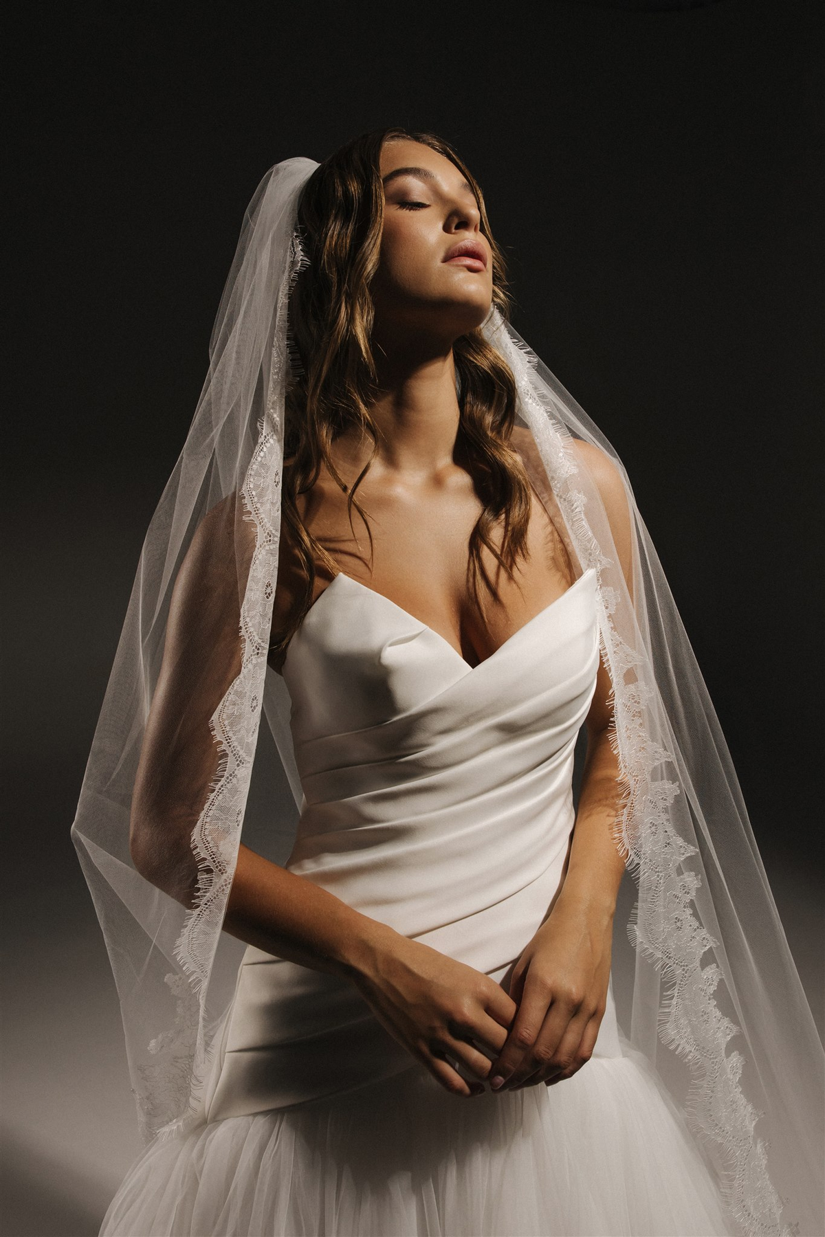SS/25 Serene Echoes - bride in a veil against a pale backdrop