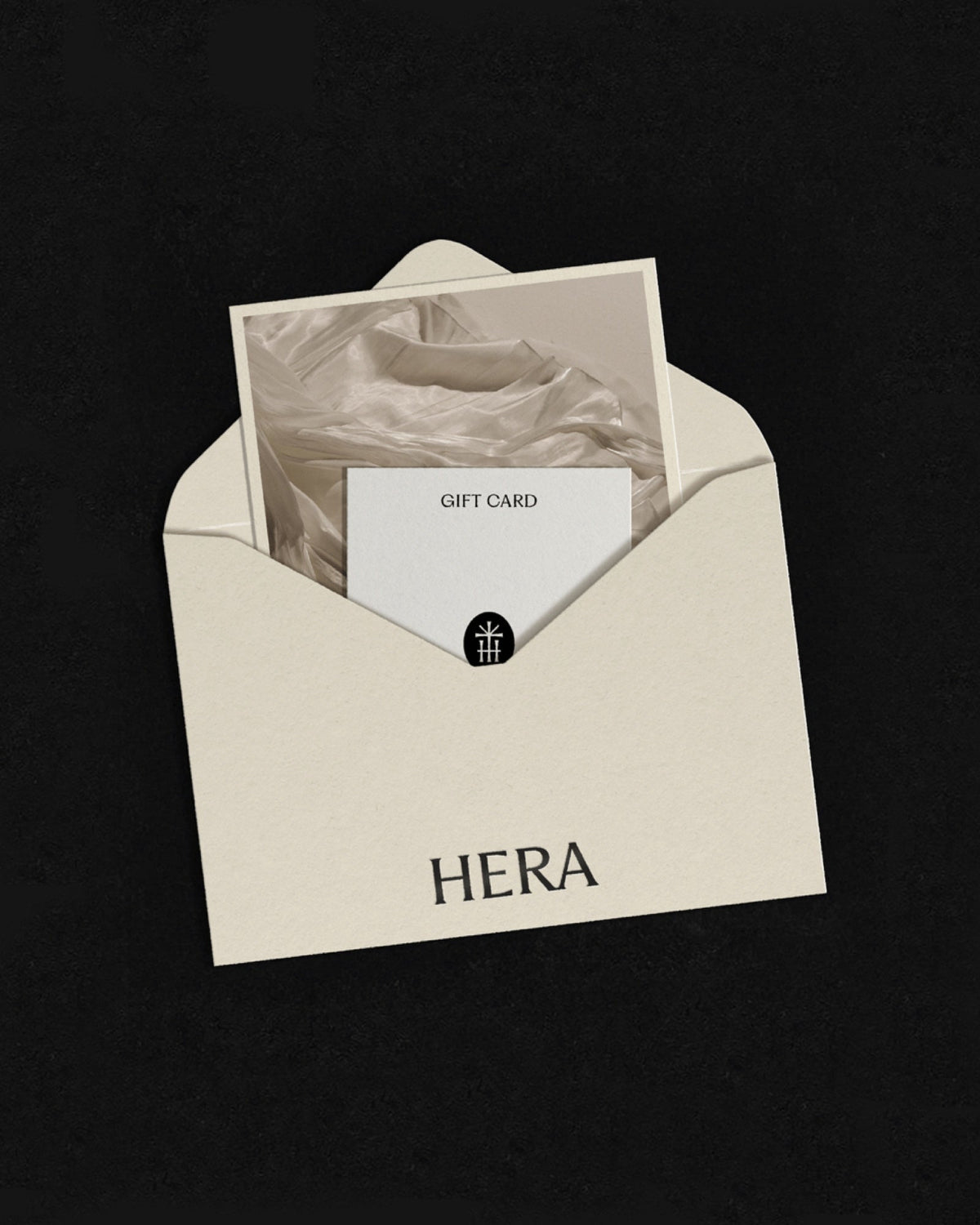 A Hera gift card in a cream envelope on a dark background