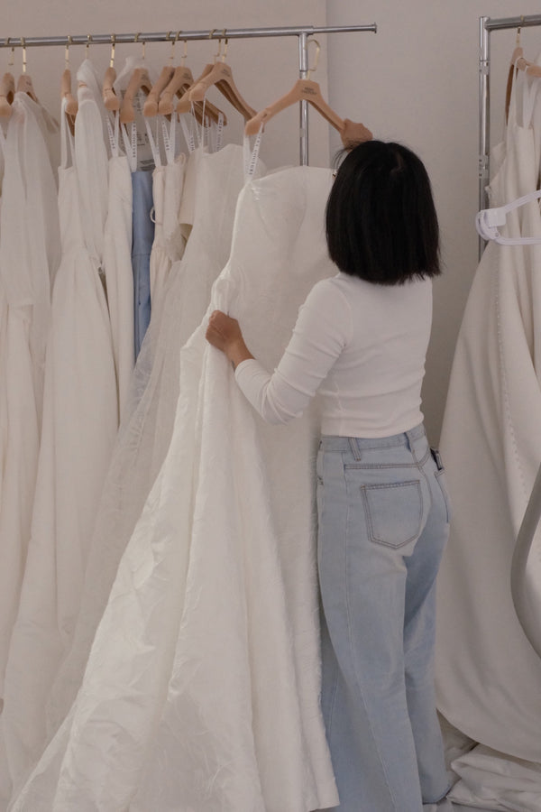 A bride trying a Hera Couture gown at a pop-up event